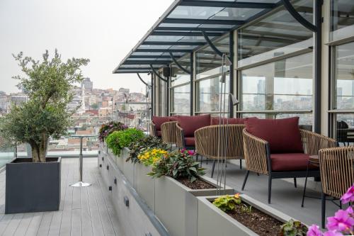 a balcony with chairs and flowers on a building at Four Points by Sheraton Istanbul Kagithane in Istanbul