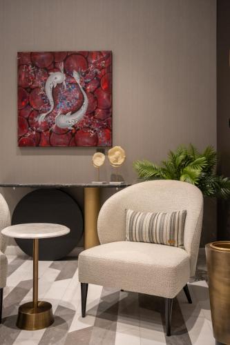 a living room with a chair and a painting at Four Points by Sheraton Istanbul Kagithane in Istanbul