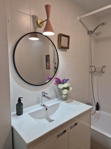 a bathroom with a sink and a mirror at Apartamento Uxín in Isaba