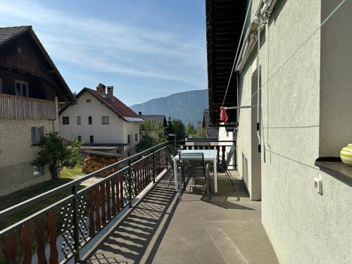 a balcony with a table on the side of a building at Apartma Rekar - a house, where you can relax in the embrace of nature in Jesenice