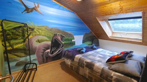 a bedroom with a dinosaur mural on the wall at Nuestro sueño jurásico in Barreiros
