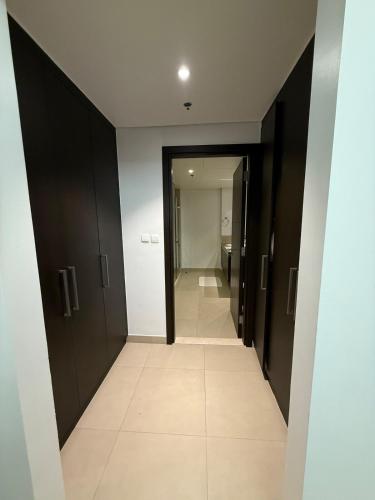 a hallway with black doors and a tile floor at 3403!Dubai SkyLine View! Royal Montania Homes in Dubai