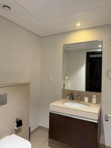 a bathroom with a sink and a large mirror at 3403!Dubai SkyLine View! Royal Montania Homes in Dubai