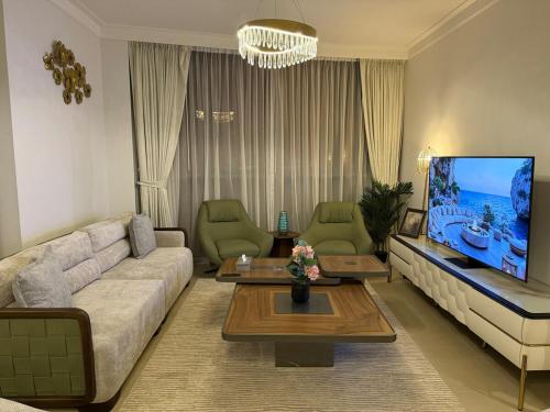 a living room with a couch and a flat screen tv at 3403!Dubai SkyLine View! Royal Montania Homes in Dubai