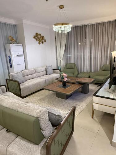 a living room with a couch and a table at 3403!Dubai SkyLine View! Royal Montania Homes in Dubai