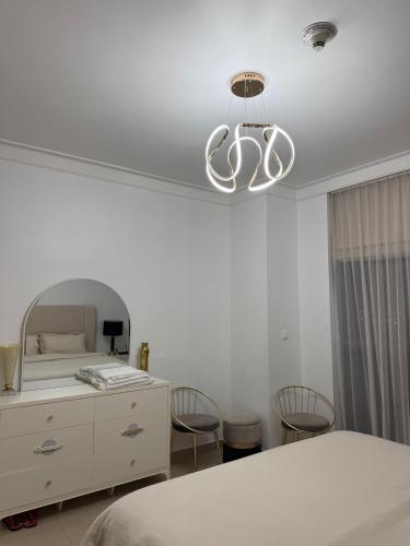 a bedroom with a bed and a dresser and a mirror at 3403!Dubai SkyLine View! Royal Montania Homes in Dubai