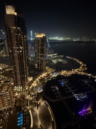 a city lit up at night with buildings and the water at 3403!Dubai SkyLine View! Royal Montania Homes in Dubai