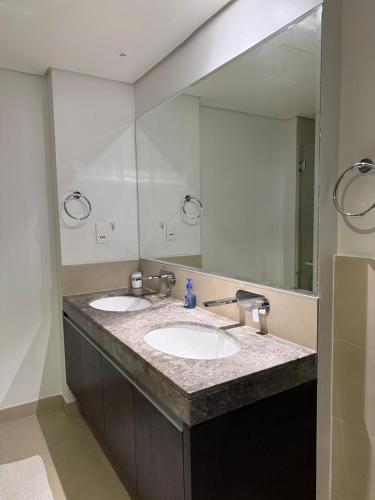 a bathroom with two sinks and a large mirror at 3403!Dubai SkyLine View! Royal Montania Homes in Dubai
