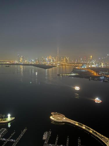 a view of a city at night with boats in the water at 3403!Dubai SkyLine View! Royal Montania Homes in Dubai