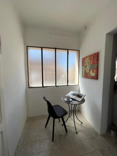 a room with a table and a chair and a window at Panorama nel borgo in Monteciccardo