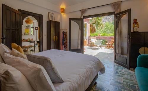 a bedroom with a large bed and a patio at Charming 5 bedroom in Marrakech