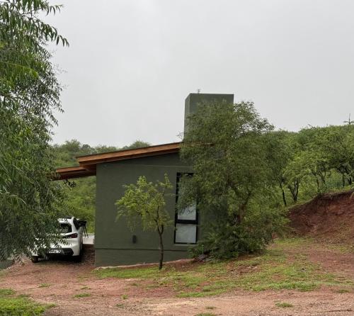 a small house with a car parked in front of it at Sierras de Córdoba Ascochinga vivienda Privada in Ascochinga