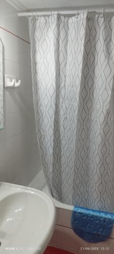 a shower curtain in a bathroom next to a sink at ΑLEXANDRAS HOUSE in Preveza