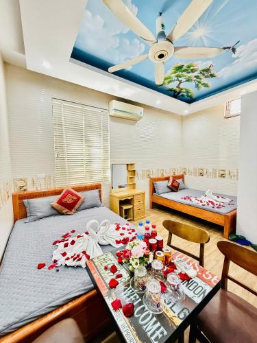 a bedroom with a bed and a table with flowers on it at Hotel Mountain View in Chinh Phú
