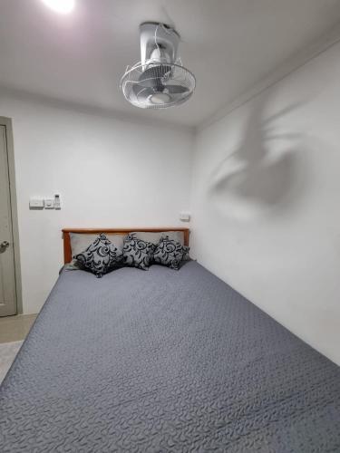 a bedroom with a large bed with pillows on it at Bula Breeze in Nadi