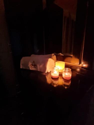 two candles sitting on a table in a dark room at Bula Breeze in Nadi