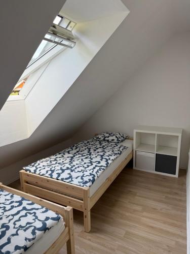 a bedroom with two beds and a window at Apartma Klemenc in Bohinj
