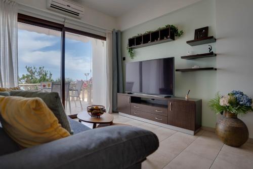 a living room with a couch and a television at Glabur Stays! The One -1 - Elite Marina Front! in Zygi