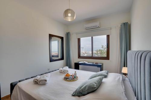 a bedroom with a bed with a tray of food on it at Glabur Stays! The One -1 - Elite Marina Front! in Zygi