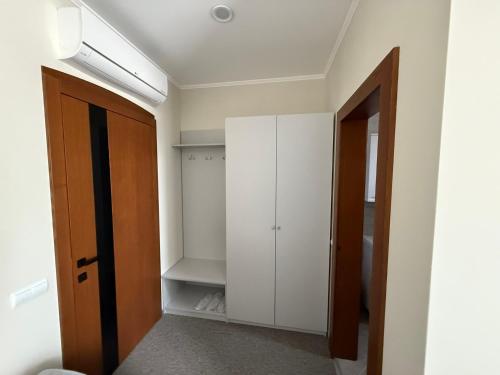 a hallway with a white closet and a door at Ресторан-Готель Шеркерт in Berehove