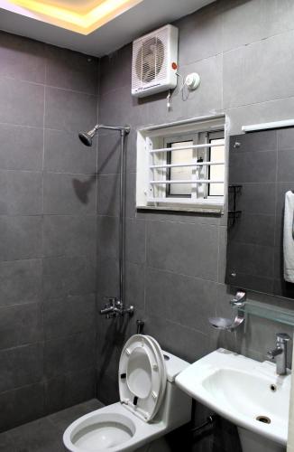 a bathroom with a toilet and a sink at Islamabad Comfort Inn in Islamabad