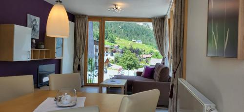 a living room with a couch and a table and a window at Bergkristall in Brand