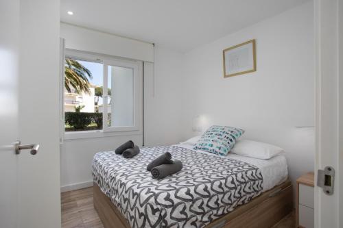 a bedroom with a bed with two stuffed animals on it at Apartament amb piscina i aparcament - Baixos amb jardinet in Calella de Palafrugell