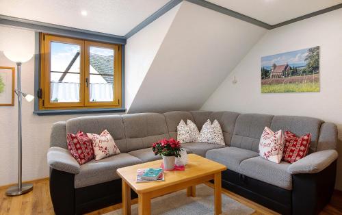a living room with a couch and a table at Ferienwohnung Atelier in Bad Bellingen