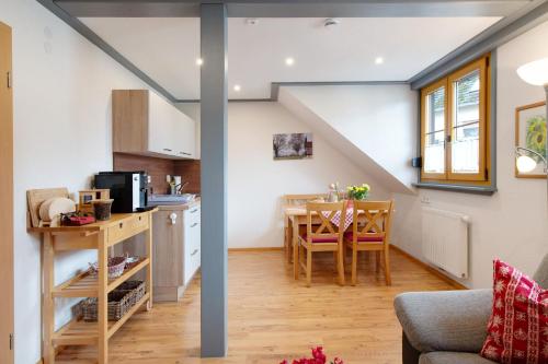 a kitchen and dining room in a tiny apartment at Ferienwohnung Atelier in Bad Bellingen