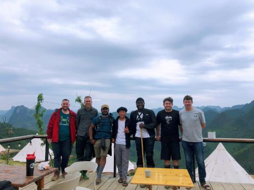 a group of people posing for a picture on a deck at Sunrise Ha Giang Camping An Introspective Stay in Kon Rung (1)