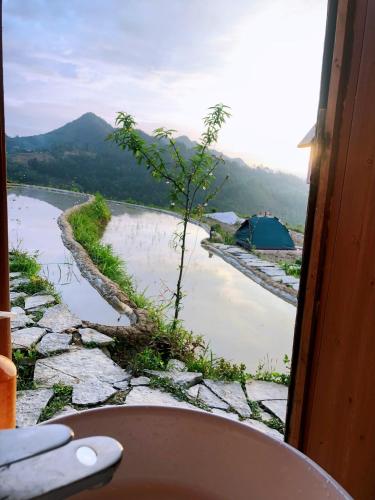 a view of a river from a window at Sunrise Ha Giang Camping An Introspective Stay in Kon Rung (1)