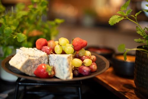 a plate of food with fruit on a table at Home Hotel Hammer in Lillehammer