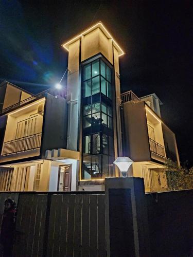 a large building with lights on top of it at night at Twilight Stays ll 2BHK Private Villa ll Swimming Pool ll AC ll BBQ in Lonavala