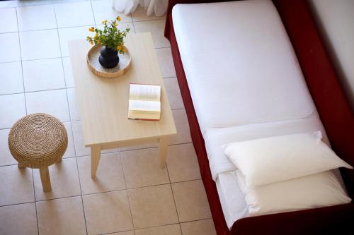 a room with a bed and a table with a book at Kiotari Bay in Kiotari