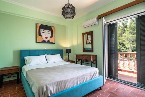 a bedroom with a bed and a large window at Villa sea view 1 in Athanion