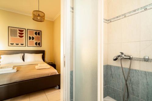 a bathroom with a shower and a bed and a shower at Villa sea view 1 in Athanion
