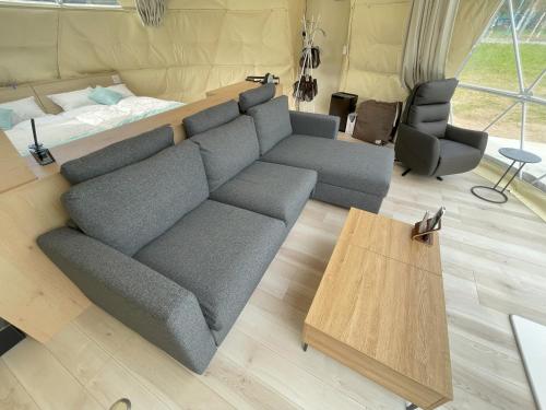 a living room with a couch and a bed at LiVEMAX RESORT Hakodate Greenpia Onuma in Mori
