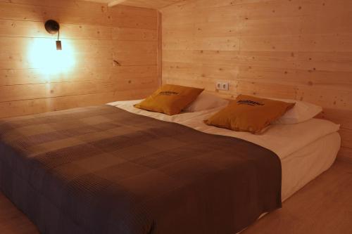 a bedroom with two beds in a wooden room at Beeography guest house in Vardablur