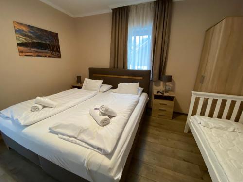 a bedroom with two beds with towels on them at Nockalm Cottage in Bad Kleinkirchheim