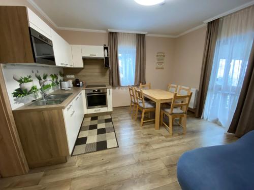 a kitchen and dining room with a table and chairs at Nockalm Cottage in Bad Kleinkirchheim