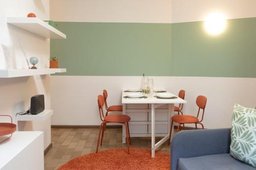 a small living room with a table and chairs at BERNINA STATION CENTRE APARTMENT 3 - three minutes walk from bernina station in Tirano