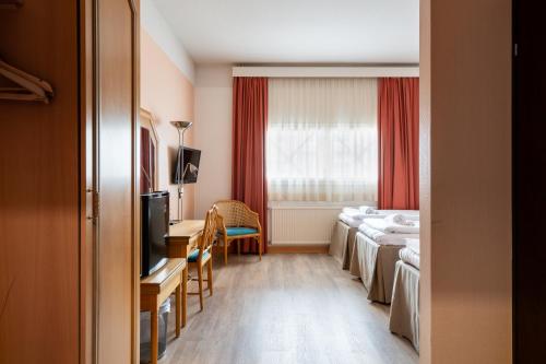 a hotel room with four beds and a window at Hiisi Hotel Turku Seaport in Turku