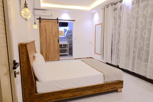a small bedroom with a bed and a window at Lotus D`Or Villa in Trou aux Biches