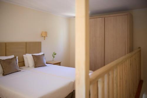 a bedroom with two beds with white sheets and pillows at Kiotari Bay in Kiotari