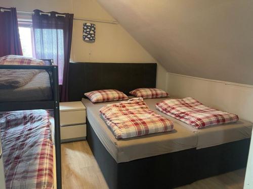 two beds in a dorm room with two bunk beds at Arctic Skyview Retreat in Tromso - with parking in Tromsø