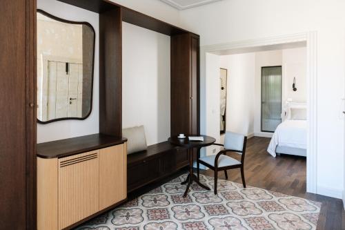 a bedroom with a desk and a mirror and a bed at Palazzina Gentile in Bari
