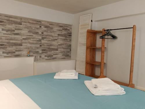 a room with two white towels on a blue floor at Old Cafe Apartment in Skala Kallirachis