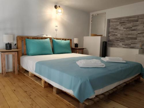 a bedroom with a bed with two towels on it at Old Cafe Apartment in Skala Kallirachis