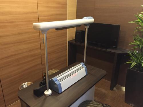 a lamp sitting on a table in a room at Fukui Manten Hotel Ekimae in Fukui