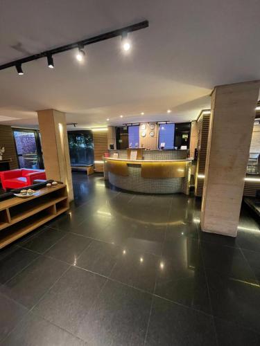 a lobby of a hotel with a bar in it at Calandre Hotel in Sao Paulo